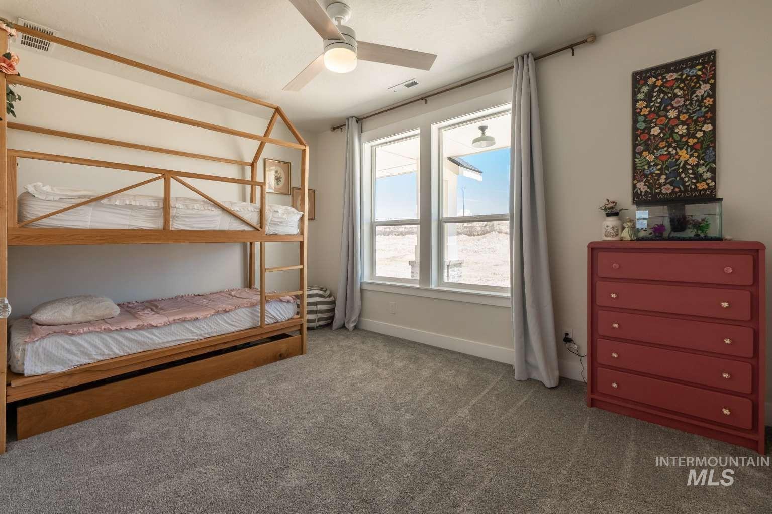 9853 Salmon Ridge Place Nampa, ID 83686 - Photo 21 of 48 Carpeted bedroom featuring ceiling fan and baseboards