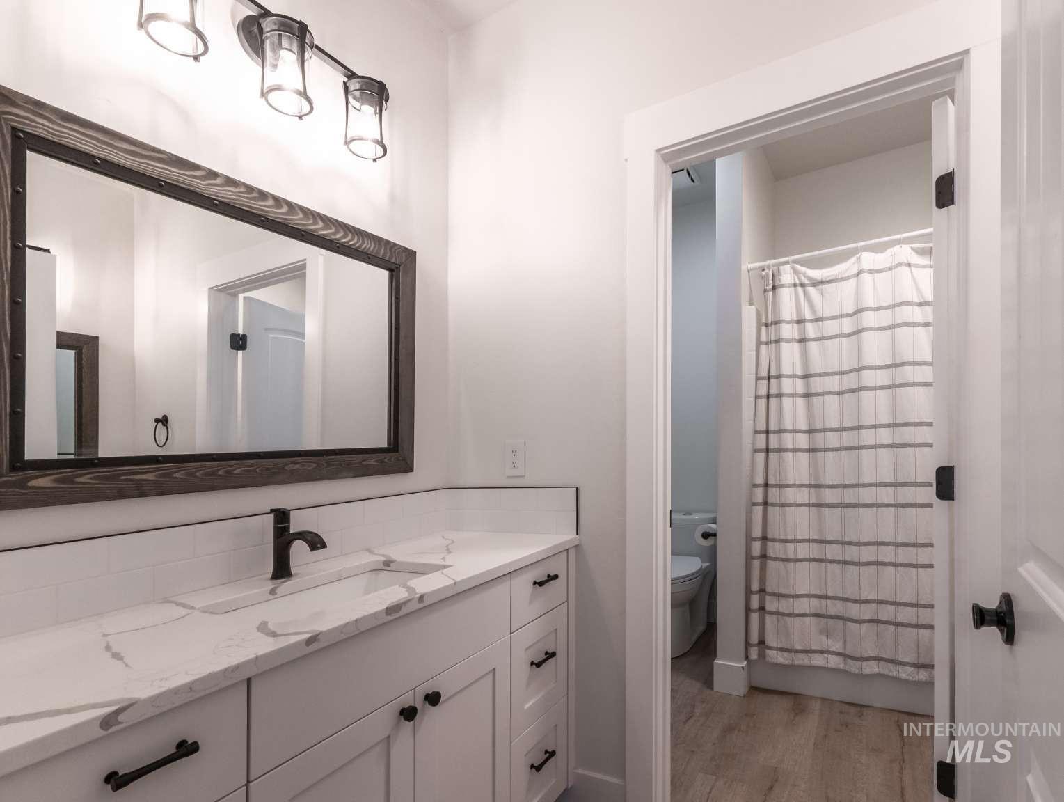 9853 Salmon Ridge Place Nampa, ID 83686 - Photo 23 of 48 Bathroom with vanity and light wood finished floors