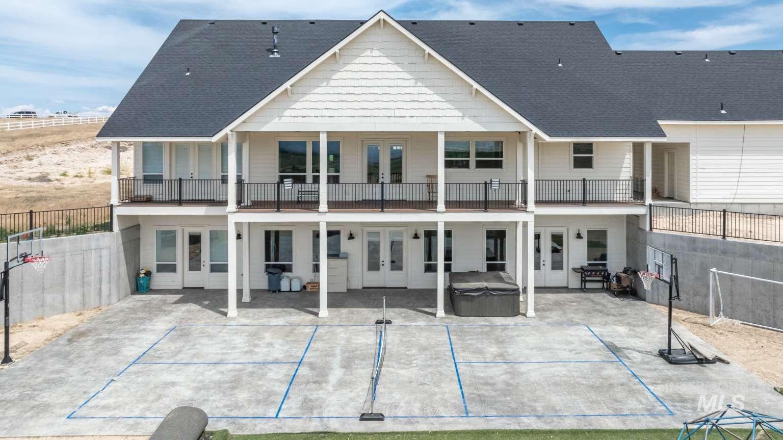 9853 Salmon Ridge Place Nampa, ID 83686 - Photo 3 of 48 Rear view of property featuring french doors, a hot tub, a patio area, and a shingled roof