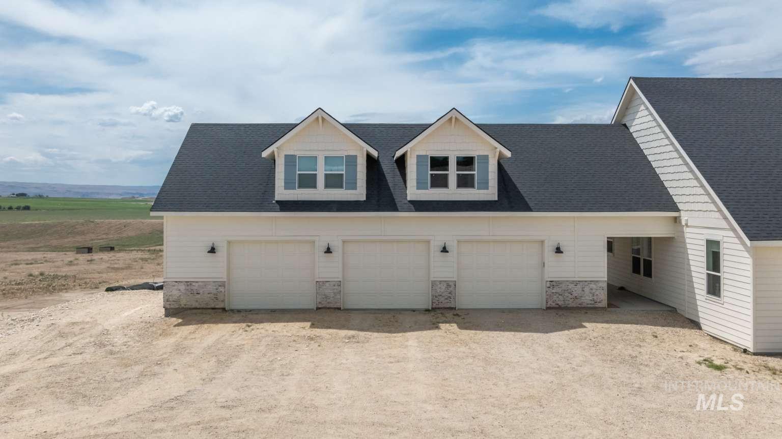 9853 Salmon Ridge Place Nampa, ID 83686 - Photo 4 of 48 View of front of home featuring dirt driveway and roof with shingles
