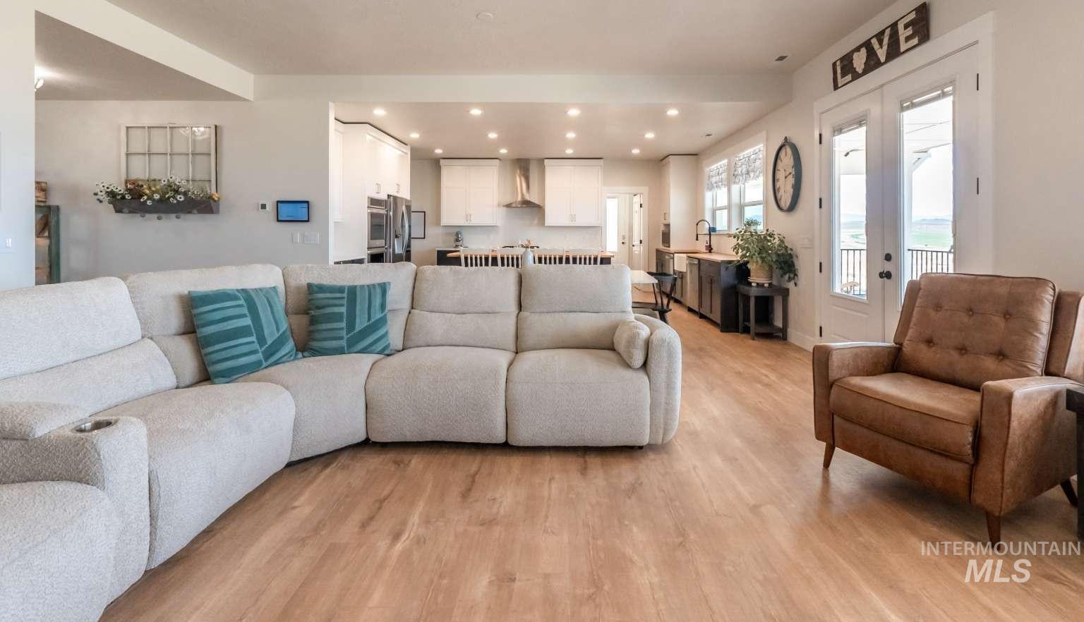 9853 Salmon Ridge Place Nampa, ID 83686 - Photo 8 of 48 Living area with light wood-type flooring, recessed lighting, and french doors