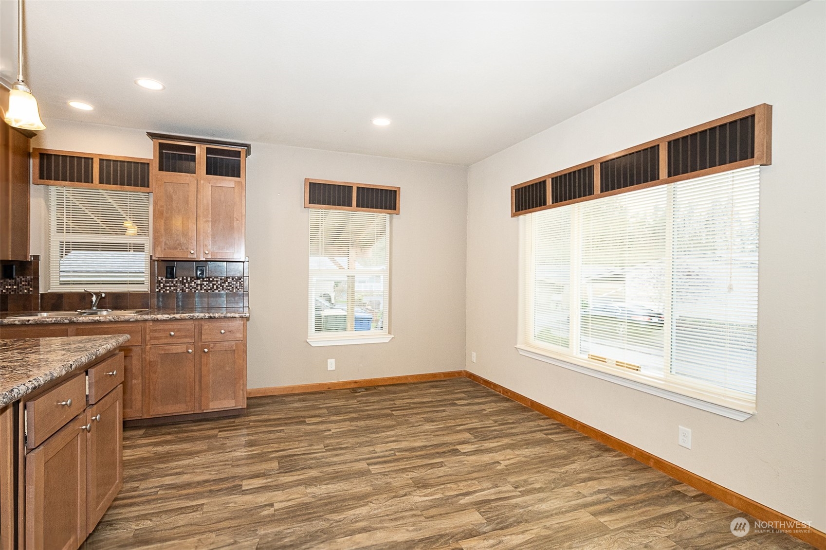 1101 South Scheuber Road, Unit 24 Centralia, WA 98531 - Photo 12 of 29 a view of a kitchen with a sink and dishwasher wooden floor