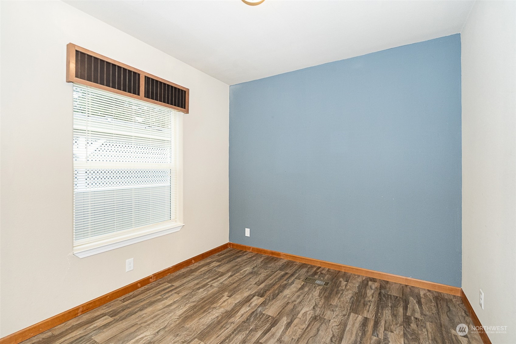 1101 South Scheuber Road, Unit 24 Centralia, WA 98531 - Photo 17 of 29 a view of an empty room with wooden floor and a window