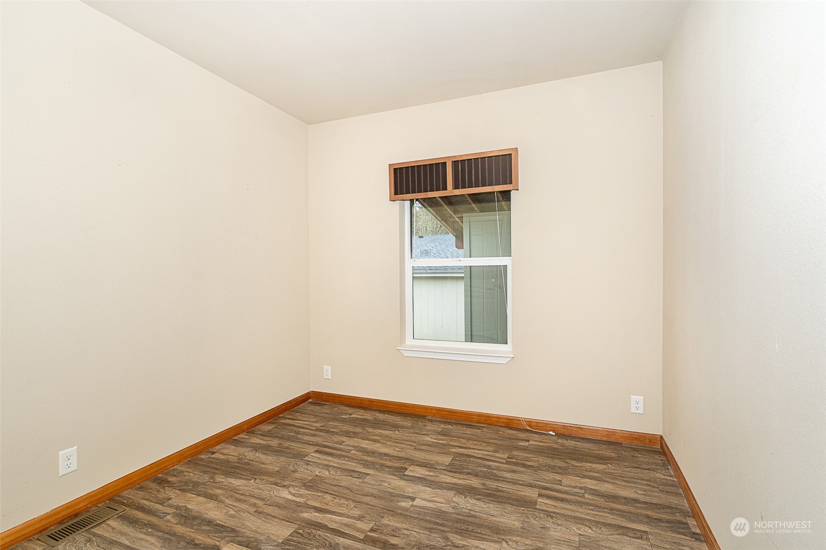 1101 South Scheuber Road, Unit 24 Centralia, WA 98531 - Photo 25 of 29 a view of an empty room with wooden floor and a window