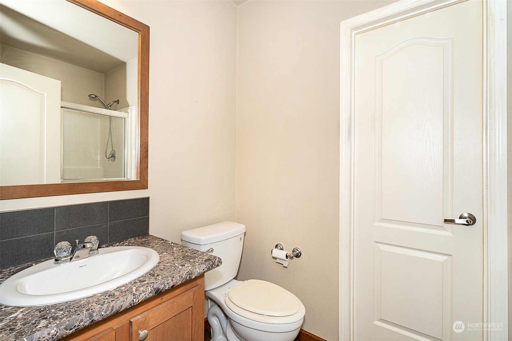 1101 South Scheuber Road, Unit 24 Centralia, WA 98531 - Photo 28 of 29 a bathroom with a granite countertop sink toilet and a mirror