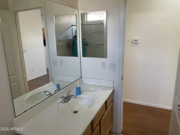 a bathroom with a sink a toilet and shower curtain