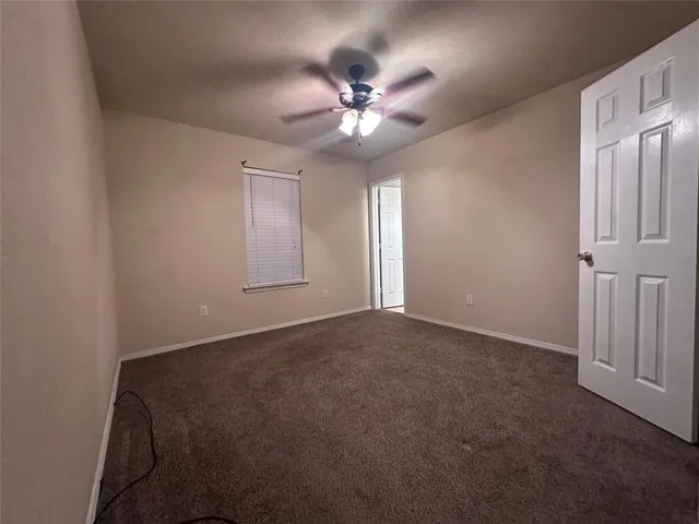 a bathroom with a toilet a sink a mirror and vanity