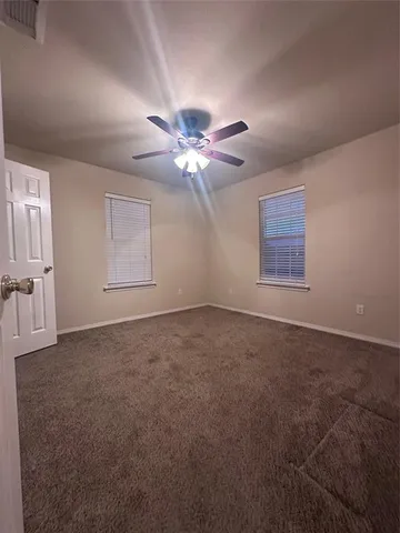 a view of a livingroom with a ceiling fan and window