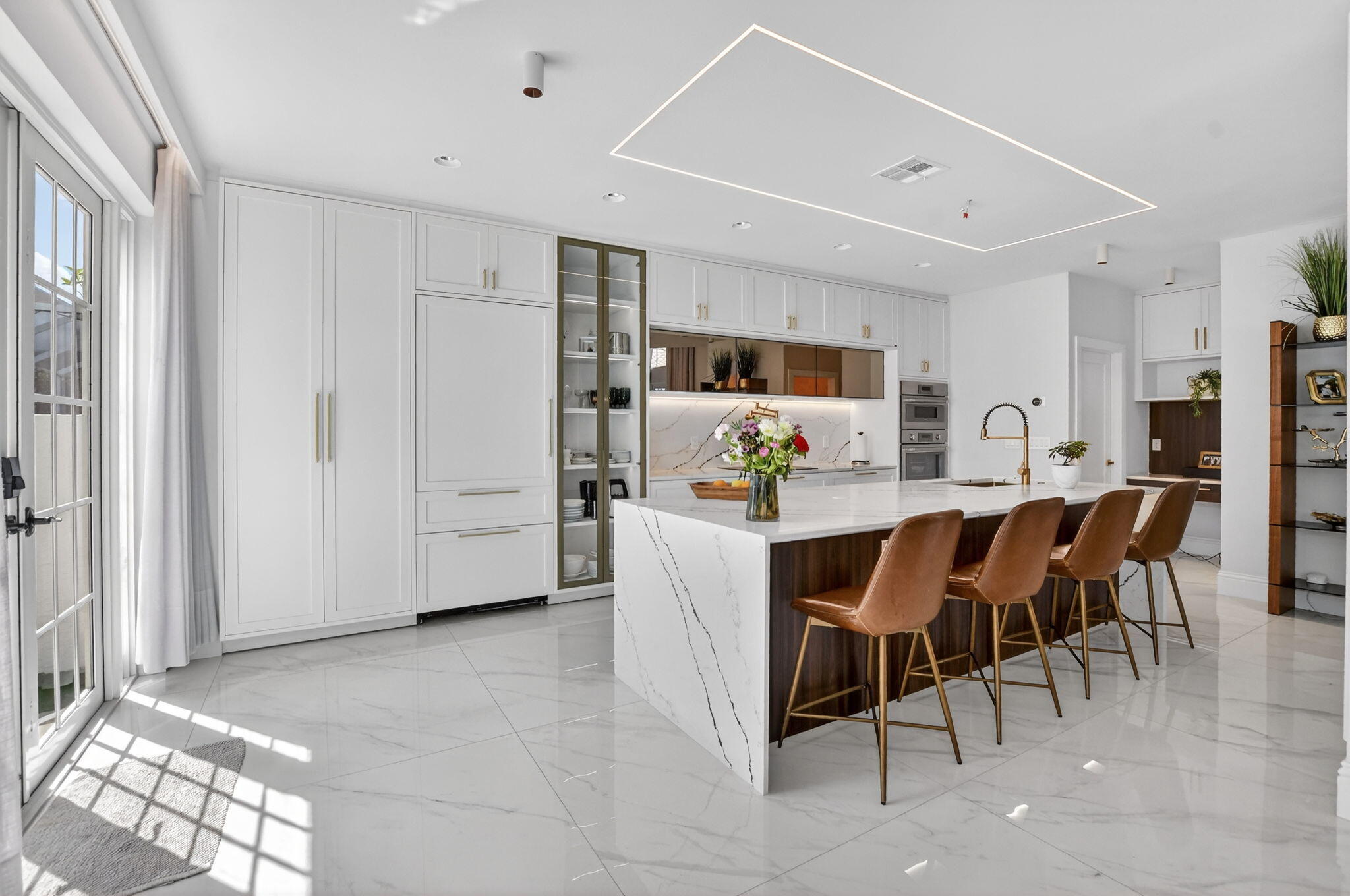 11038 Baybreeze Way Boca Raton, FL 33428 - Photo 19 of 95 a kitchen with stainless steel appliances a refrigerator a stove a dining table and chairs with wooden floor