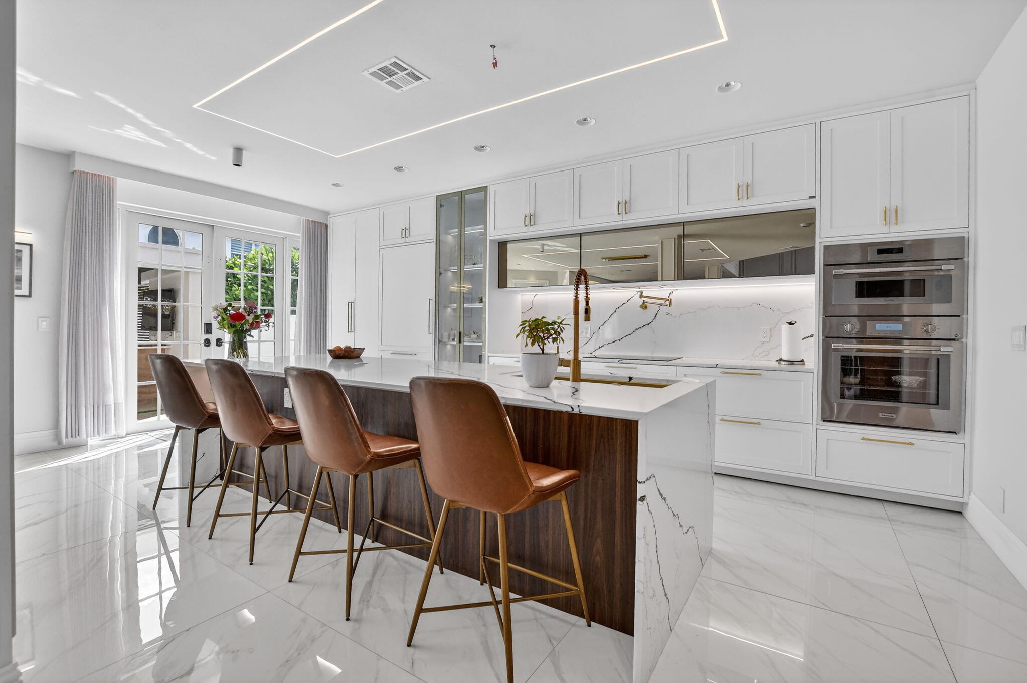 11038 Baybreeze Way Boca Raton, FL 33428 - Photo 24 of 95 a kitchen with stainless steel appliances kitchen island granite countertop a table chairs and a refrigerator