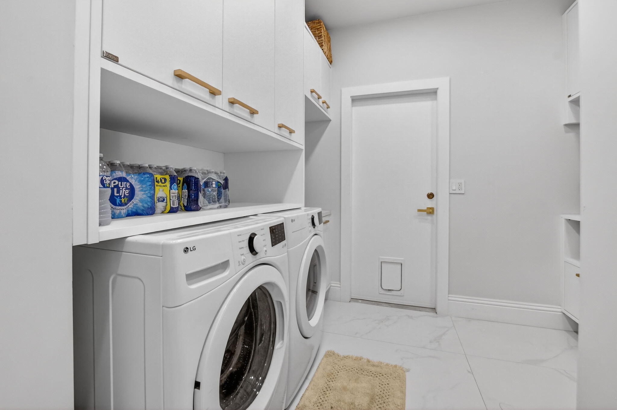 11038 Baybreeze Way Boca Raton, FL 33428 - Photo 32 of 95 a view of washer and dryer with kitchen in the background
