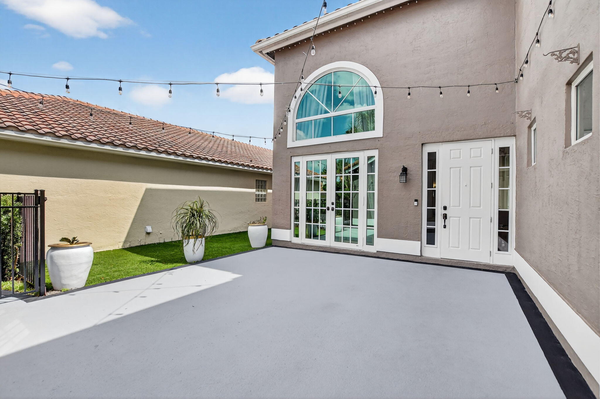 11038 Baybreeze Way Boca Raton, FL 33428 - Photo 64 of 95 a view of a house with a small yard and a large window