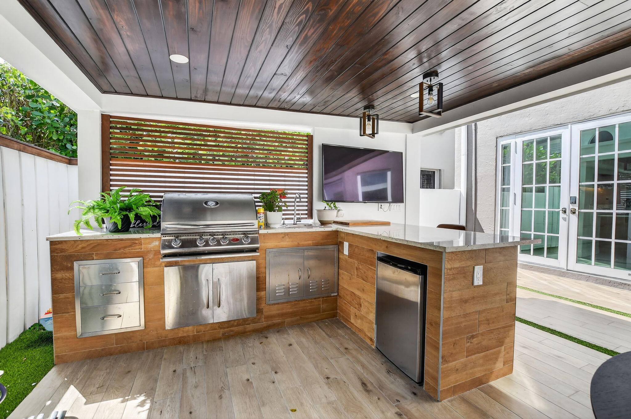 11038 Baybreeze Way Boca Raton, FL 33428 - Photo 72 of 95 a kitchen with stainless steel appliances granite countertop a sink a stove and a wooden floors