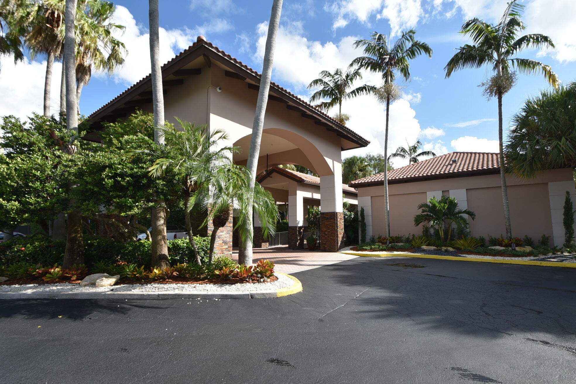 11038 Baybreeze Way Boca Raton, FL 33428 - Photo 80 of 95 a front view of a house with a yard and potted plants