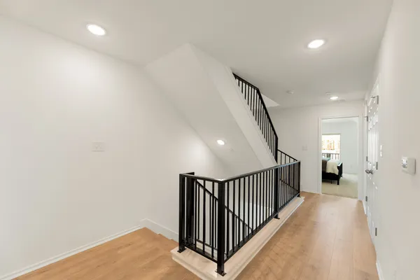 an empty room with a ceiling fan and windows