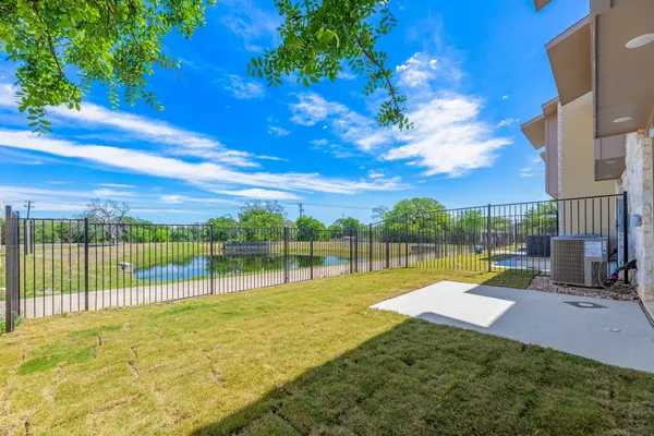 a view of swimming pool with a backyard and a tree
