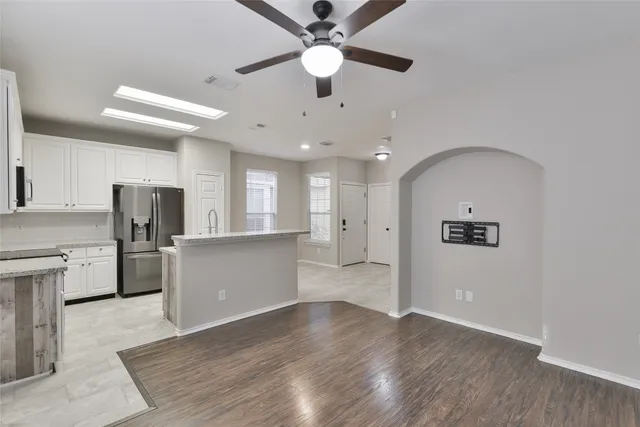 a view of a kitchen with a sink and a refrigerator