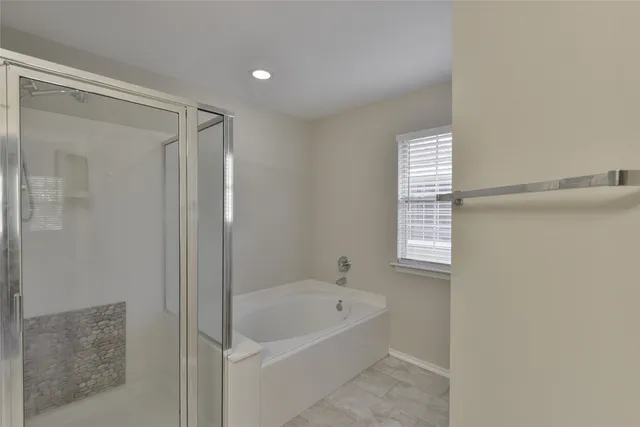 a bathroom with a bathtub and shower