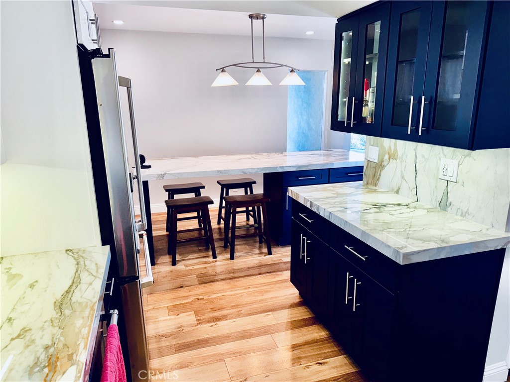 1541 Buena Vista, Unit 1 San Clemente, CA 92672 - Photo 2 of 17 a kitchen with stainless steel appliances granite countertop a sink stove and refrigerator