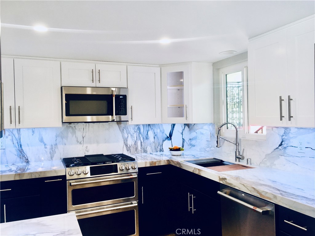 1541 Buena Vista, Unit 1 San Clemente, CA 92672 - Photo 3 of 17 a kitchen with a sink and stainless steel appliances