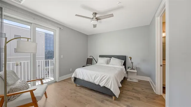 a bedroom with a bed window and a ceiling fan
