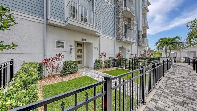 a view of a porch with plants and wooden fence