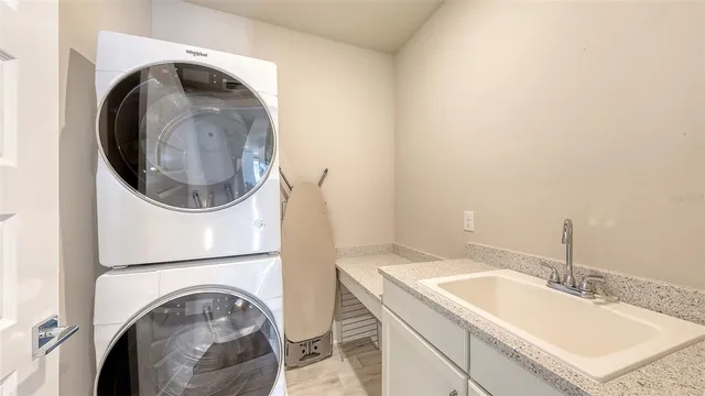 a utility room with a sink a washer and dryer