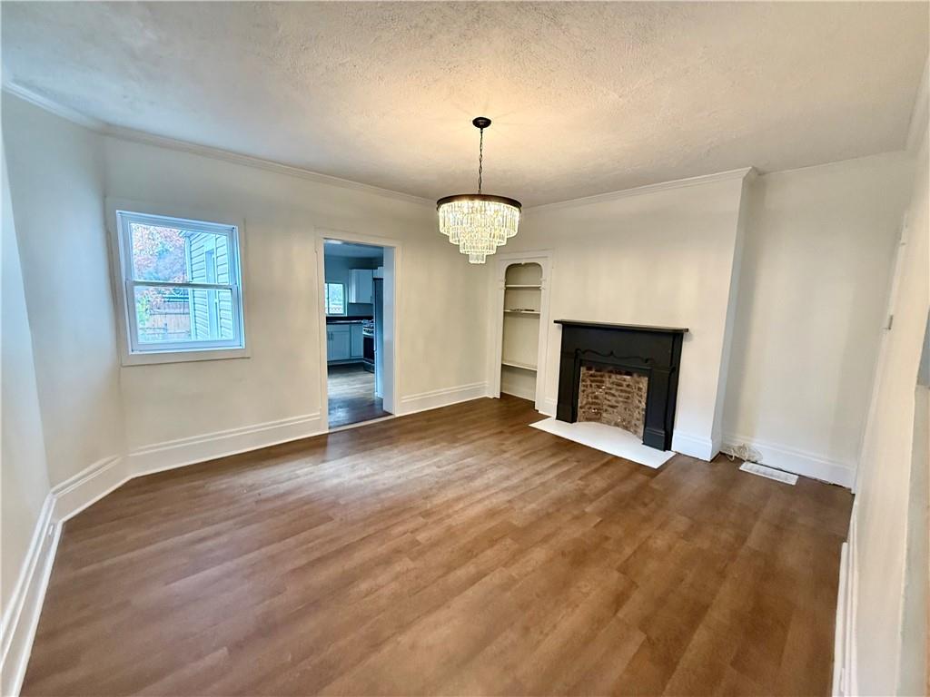 1407 Monterey Street Pittsburgh, PA 15212 - Photo 3 of 16 a view of an empty room with a fireplace and a window