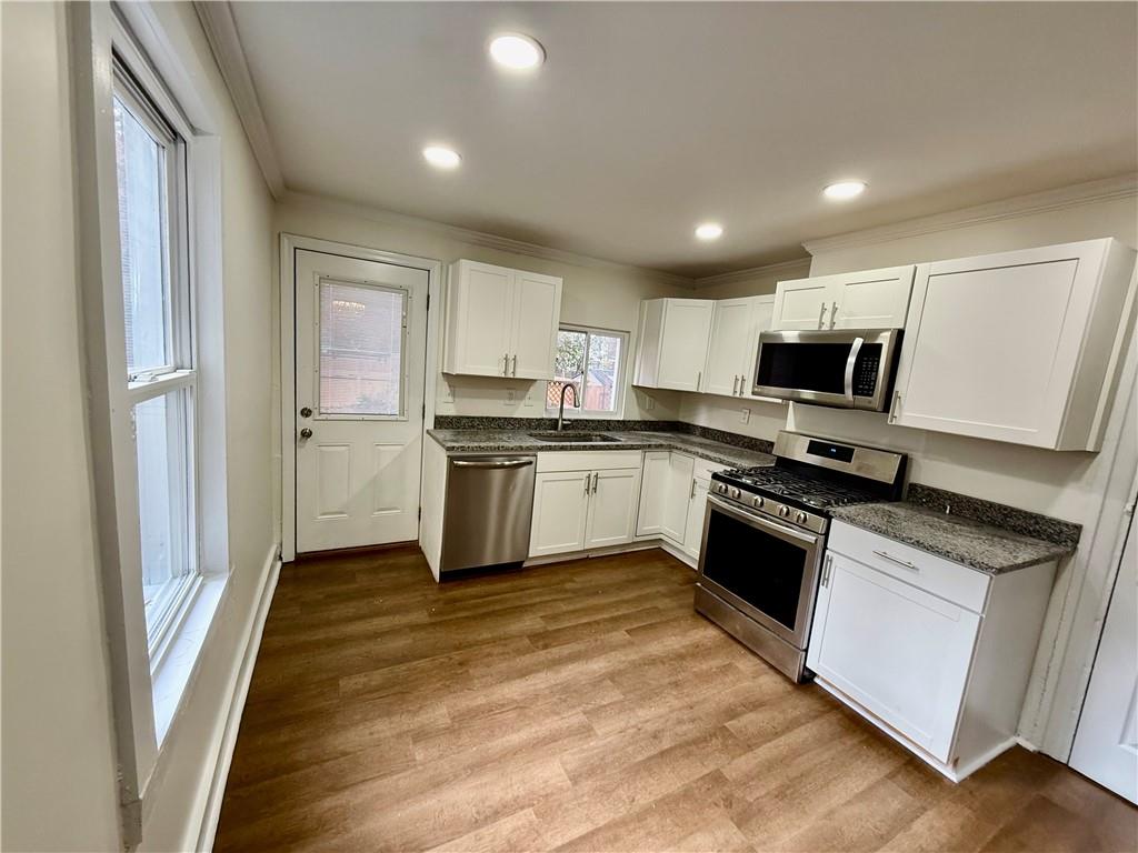 1407 Monterey Street Pittsburgh, PA 15212 - Photo 5 of 16 a kitchen with granite countertop stainless steel appliances and wooden cabinets