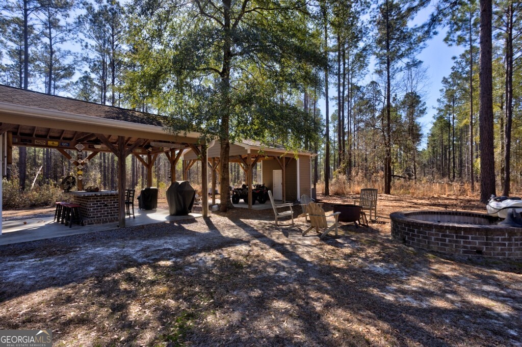 1401 Messex Road Millen, GA 30442 - Photo 13 of 51 a view of a house with backyard porch and sitting area