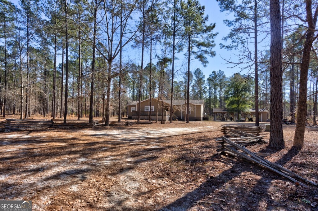 1401 Messex Road Millen, GA 30442 - Photo 8 of 51 a street view with large trees