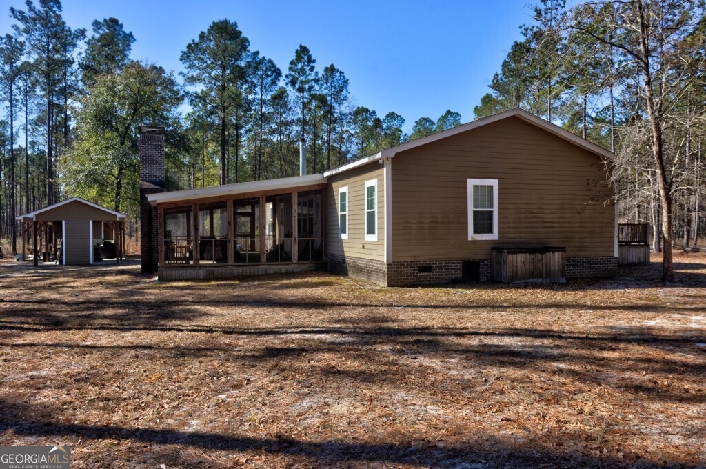1401 Messex Road Millen, GA 30442 - Photo 10 of 51 a backyard of a house with lots of green space