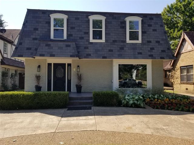 a view of a brick building with many windows