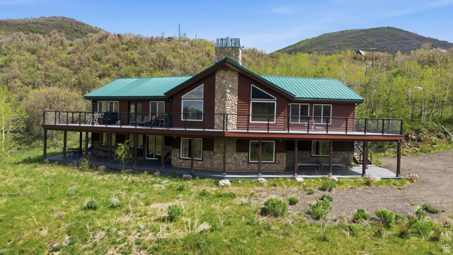 6 Beaver Springs Rancheros Oakley, UT 84055 - Photo 50 of 68 Multi-level residence featuring a green metal roof and stone veneer accents