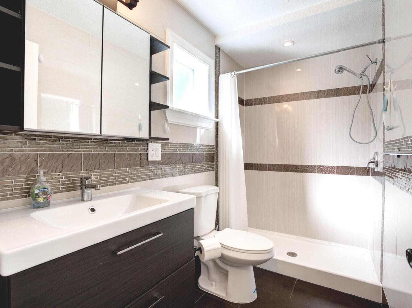 6100 Francis Street, Unit B Jupiter, FL 33458 - Photo 12 of 19 a bathroom with a sink a toilet and shower