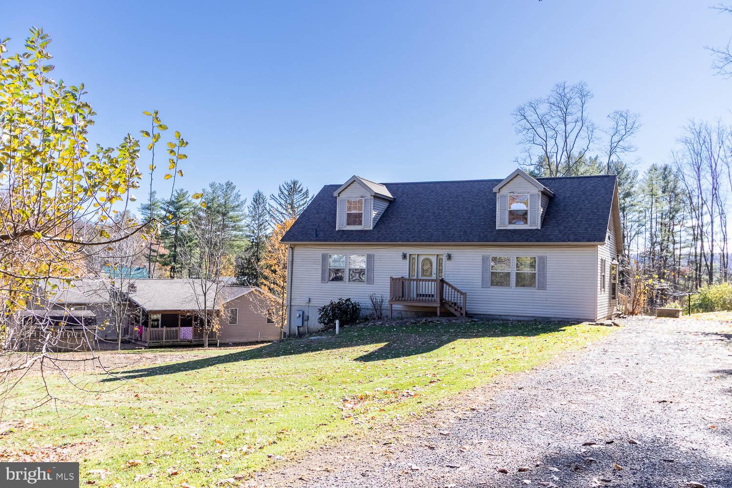 a view of a house with a yard and trees