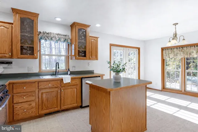 a spacious bathroom with a granite countertop sink a mirror and a bathtub