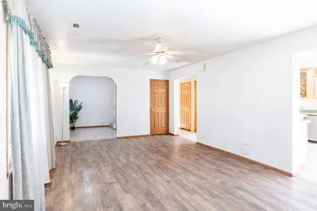 wooden floor in an empty room with a window