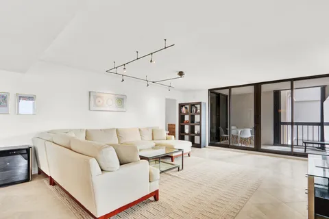 a living room with furniture and large windows