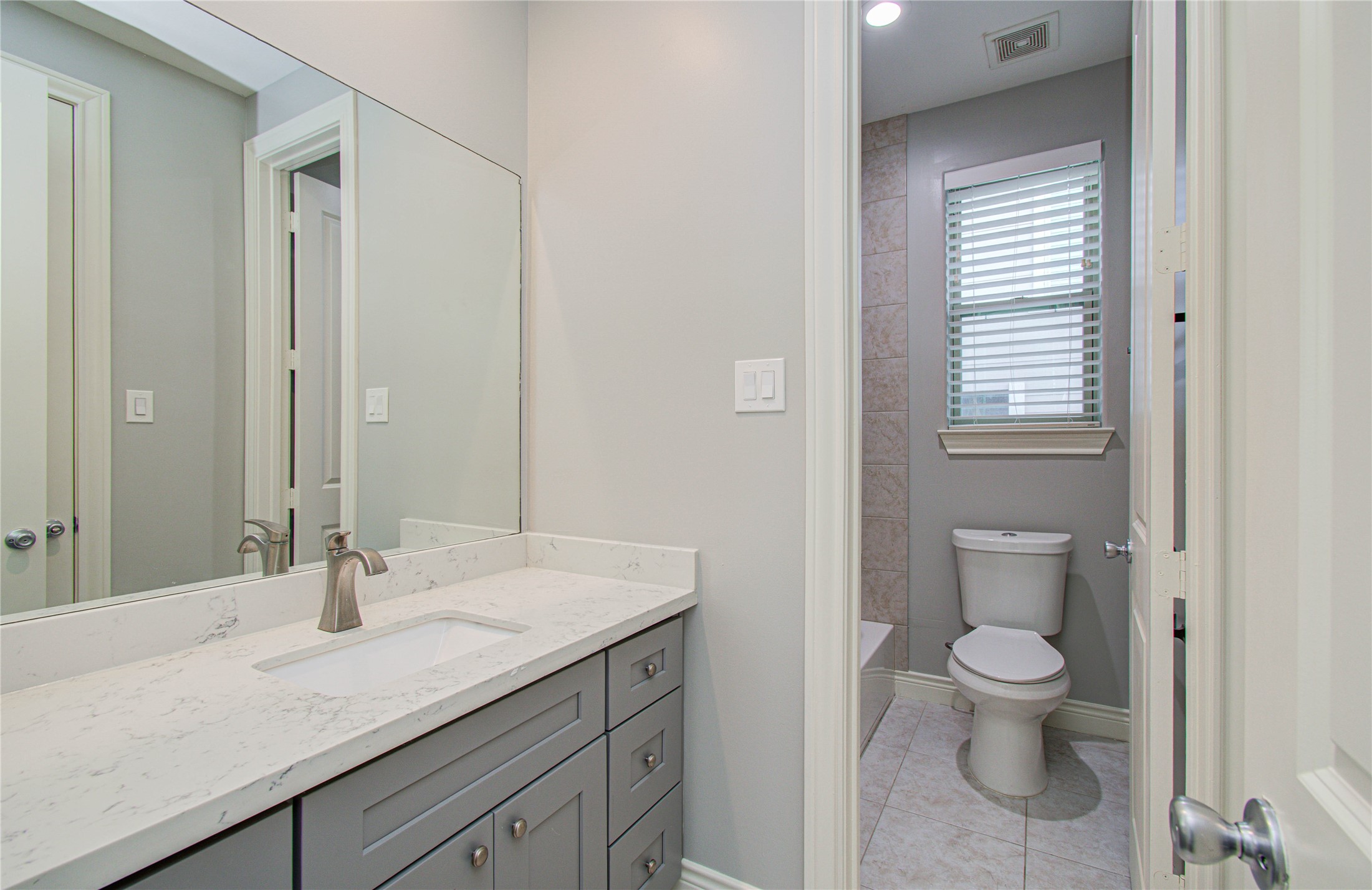 8903 Spring Knoll Forest Drive Houston, TX 77080 - Photo 14 of 29 a bathroom with a granite countertop sink toilet and mirror