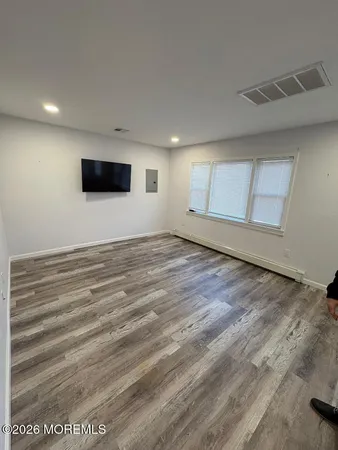 a view of a livingroom with an empty space and a window