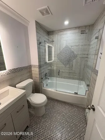a bathroom with a toilet and a shower