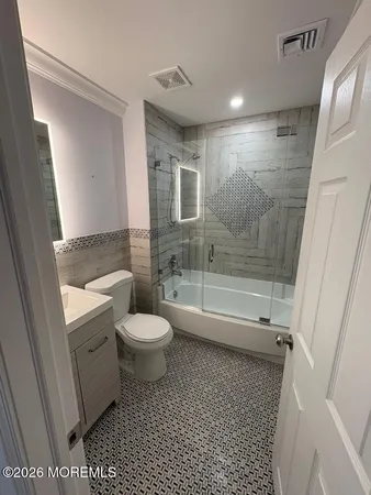a bathroom with a shower a toilet and a sink