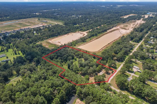 an aerial view of lake and residential houses with outdoor space