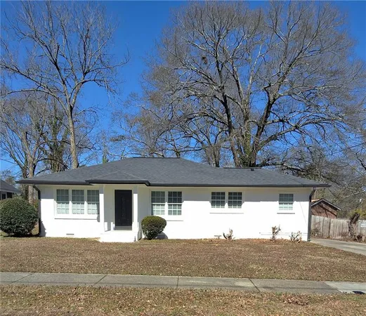 a front view of a house with a tree
