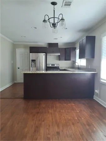 a kitchen with stainless steel appliances granite countertop a sink and a stove