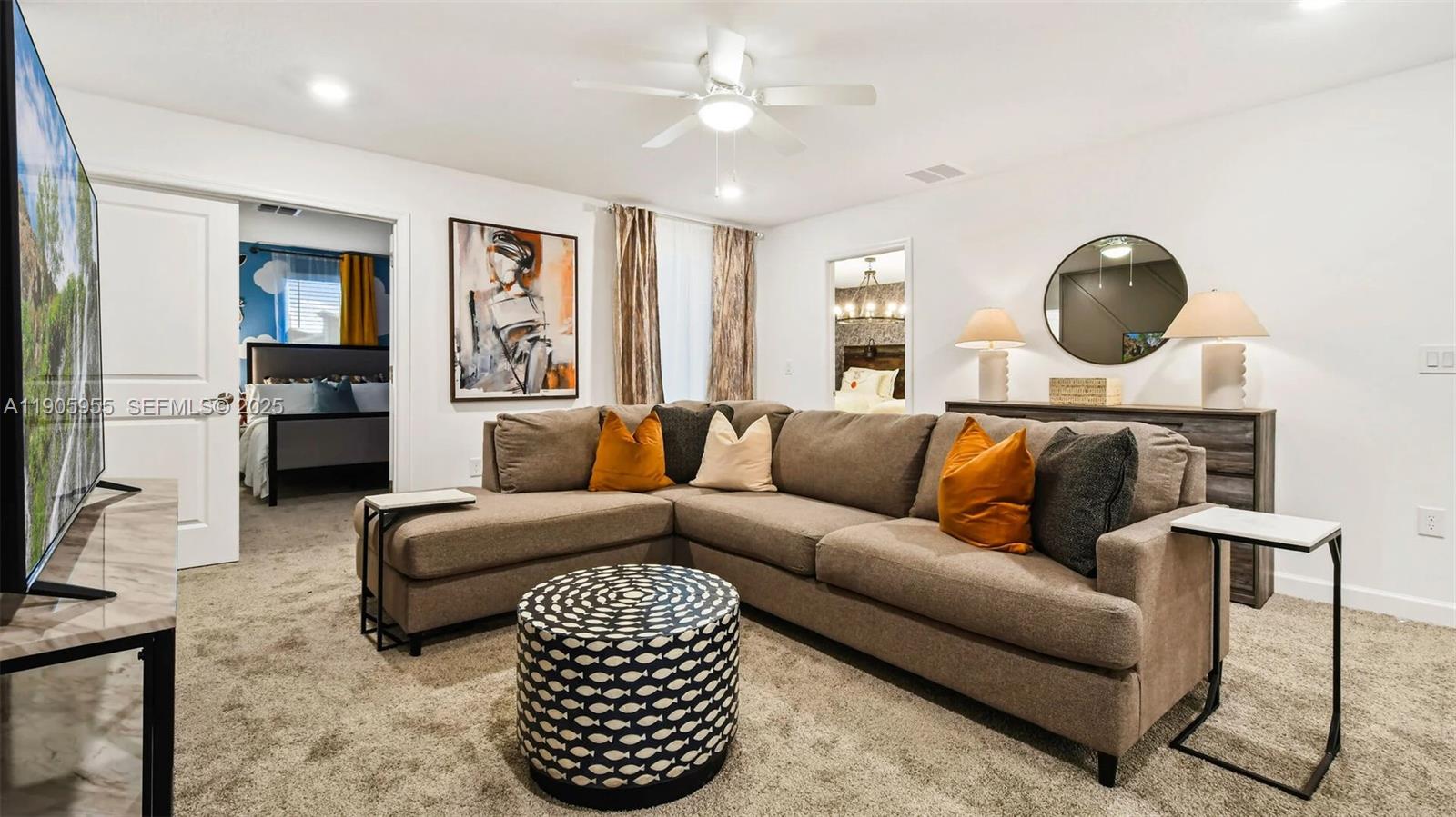 2993 Protagonist Street Kissimmee, FL 34746 - Photo 3 of 31 a living room with furniture a rug and a chandelier