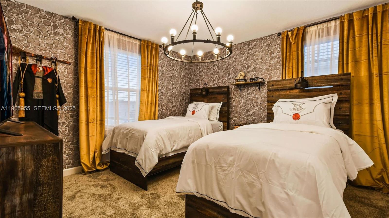 2993 Protagonist Street Kissimmee, FL 34746 - Photo 8 of 31 a spacious bedroom with two beds and a chandelier