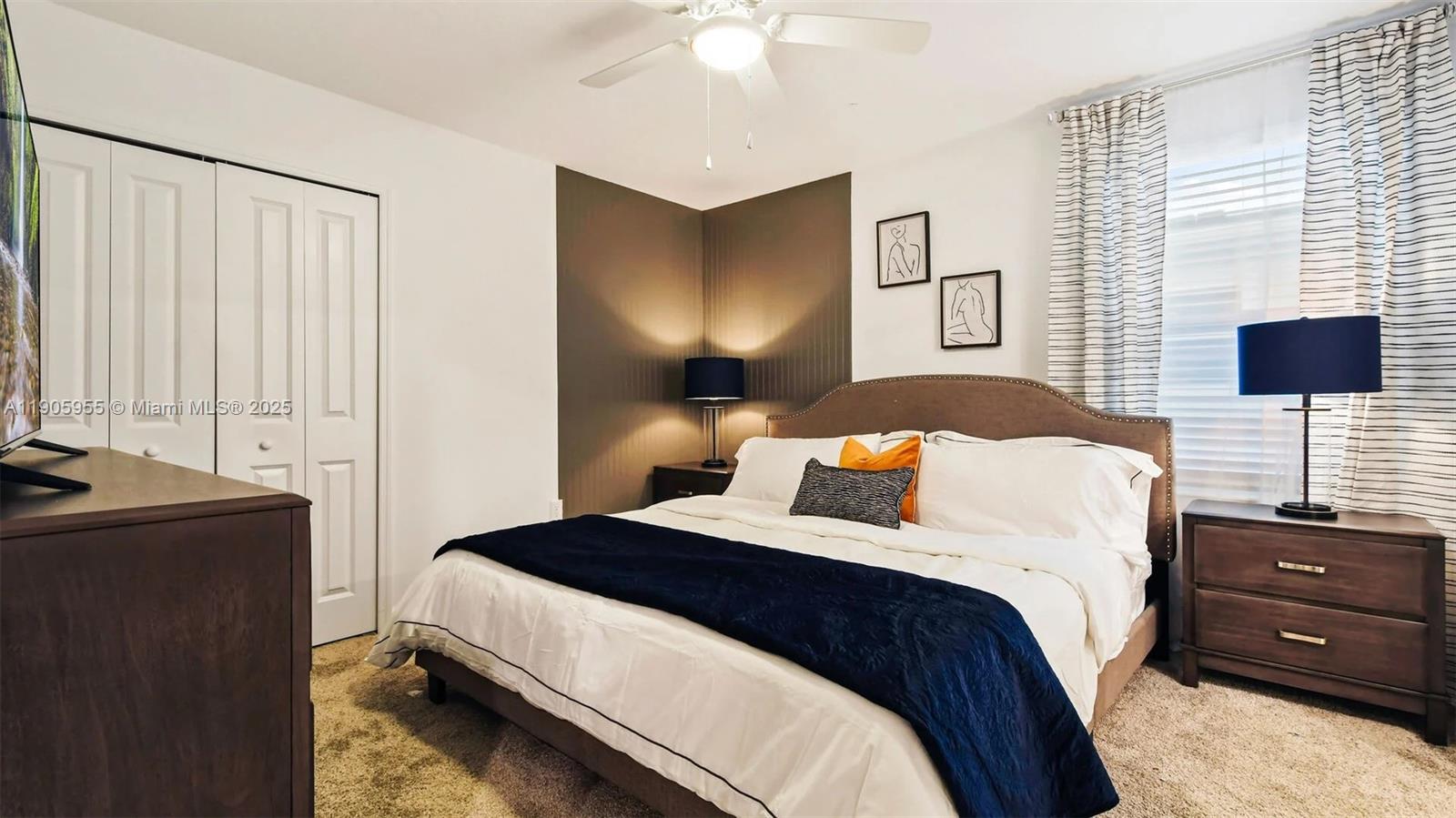 2993 Protagonist Street Kissimmee, FL 34746 - Photo 10 of 31 a bedroom with a bed and a flat tv screen on dresser