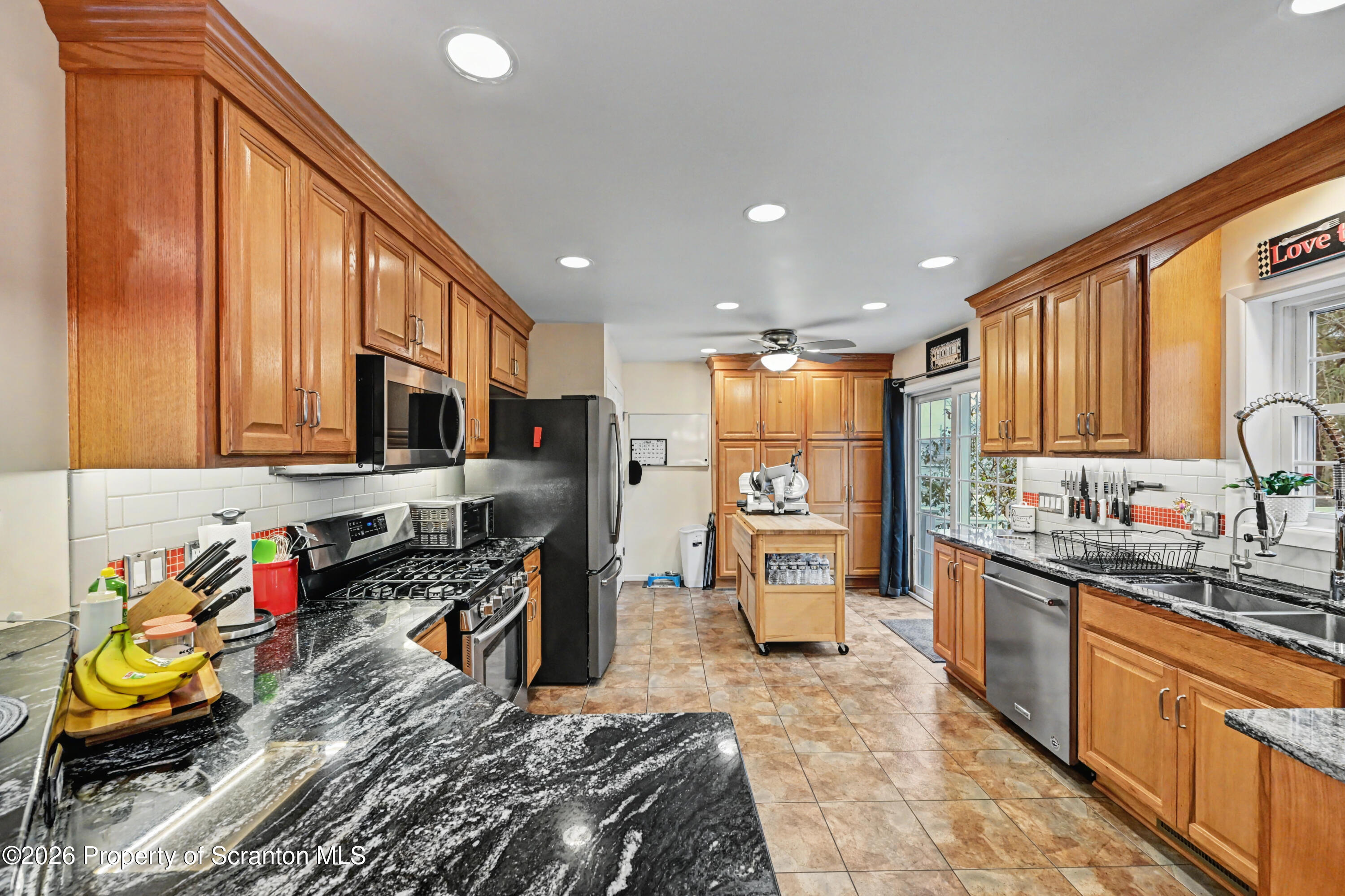 131 Front Street Jessup, PA 18434 - Photo 16 of 58 a kitchen with stainless steel appliances granite countertop a refrigerator sink and cabinets
